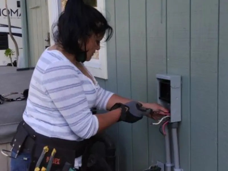 Licensed electrician wiring an exterior subpanel in Malone