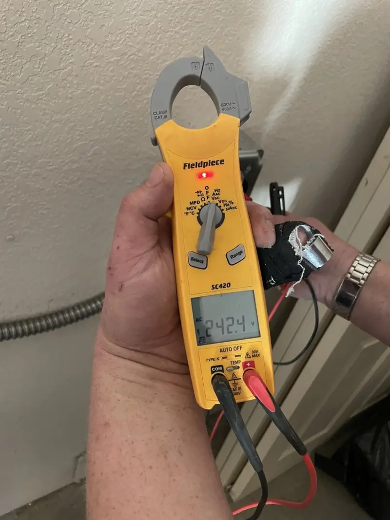 Voltage testing with clamp meter during Ceiling Fan Installation in Malone